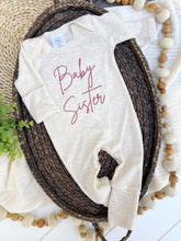 Load image into Gallery viewer, Long sleeve baby romper with pink embroidery that says "baby sister."