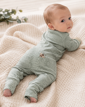 Load image into Gallery viewer, Baby wearing a heather sage green romper with a small printed bee on the back.