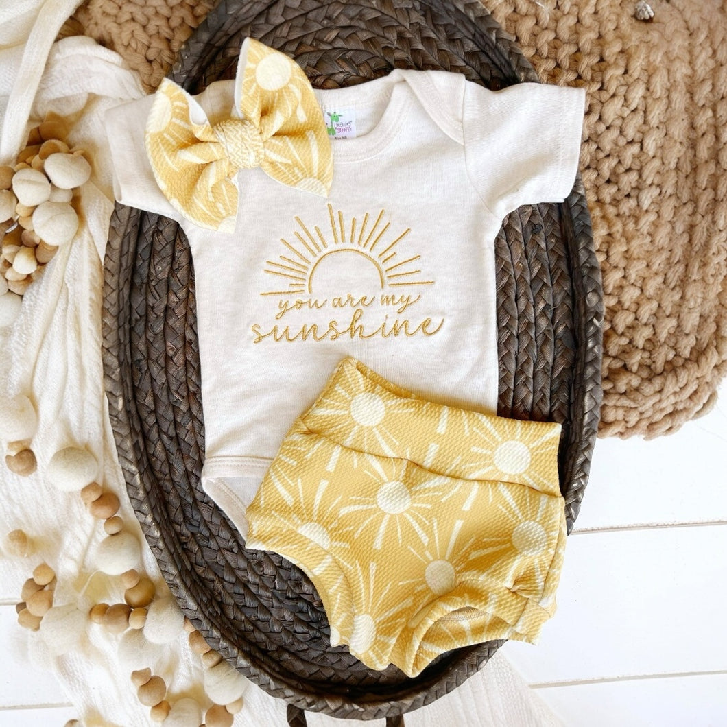 Snap onesie with embroidery that says 