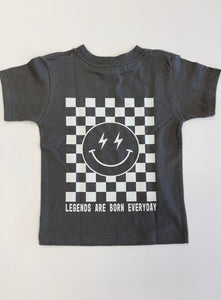 Gray short sleeve tee shirt. Smiley face and checked graphic on back with text "Legends are born everyday"