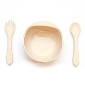 Cream colored  children's bowl and utensil set.