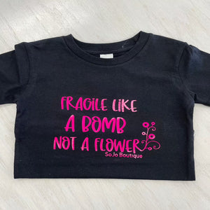 Black cotton girls tee shirt. Writing "Fragile like a bomb not a flower."