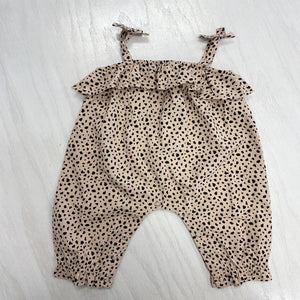 Tan leopard print baby romper. This one piece romper has bows on the straps and snap closure for easy changing.