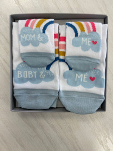 Gift box with 2 pairs of socks. Baby socks say, "Mom & me." Mom socks say, "Baby & me." Both have rainbows, clouds and hearts. Great gift set for new moms!