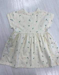Cream colored girls' dress with quality, breathable cotton and dainty pattern.