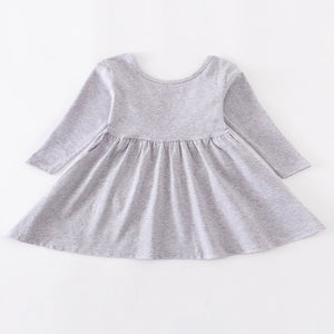 Gray girls dress with a-line hem adorned with a bow on the back and pockets on the sides.