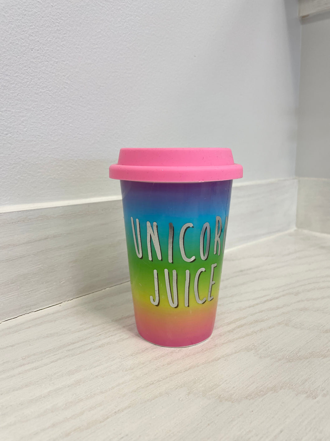Vibrant ceramic cup with lid.