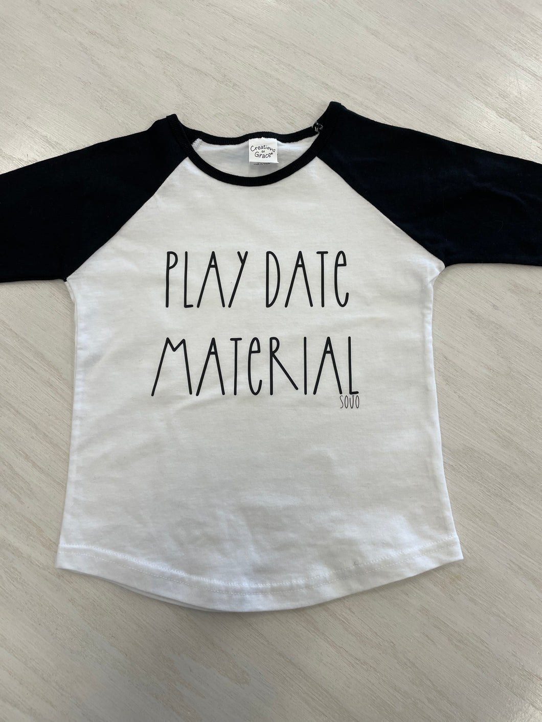 Black and white baseball style shirt with wording 
