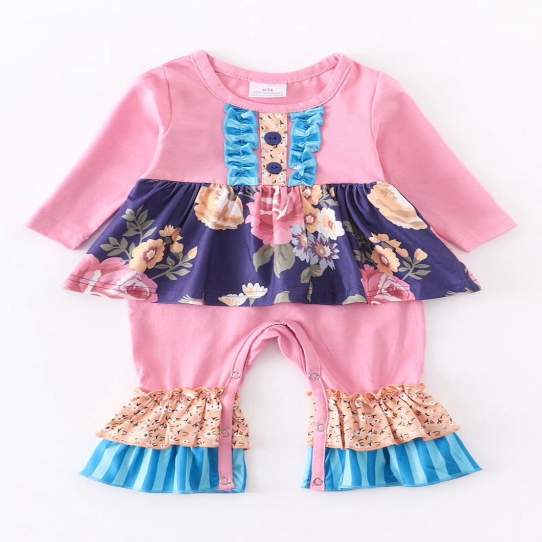One-piece infant romper with attached floral skirt, ruffles and unique patterns.