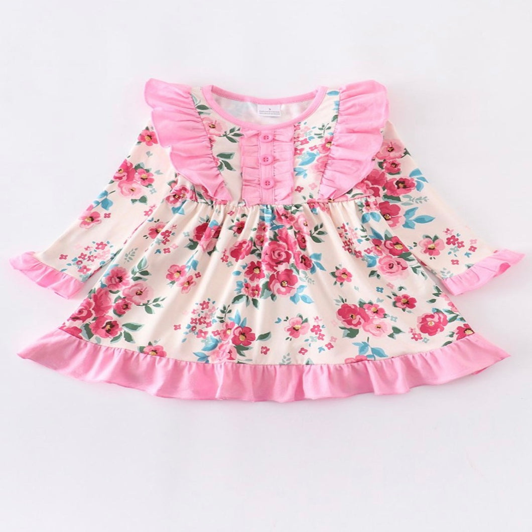Floral girls dress. Adorned with elegant ruffle details. Perfect for any special occasion.