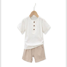 Load image into Gallery viewer, Light weight boys summer set. Featuring white short sleeve top with buttons and creams colored shorts.
