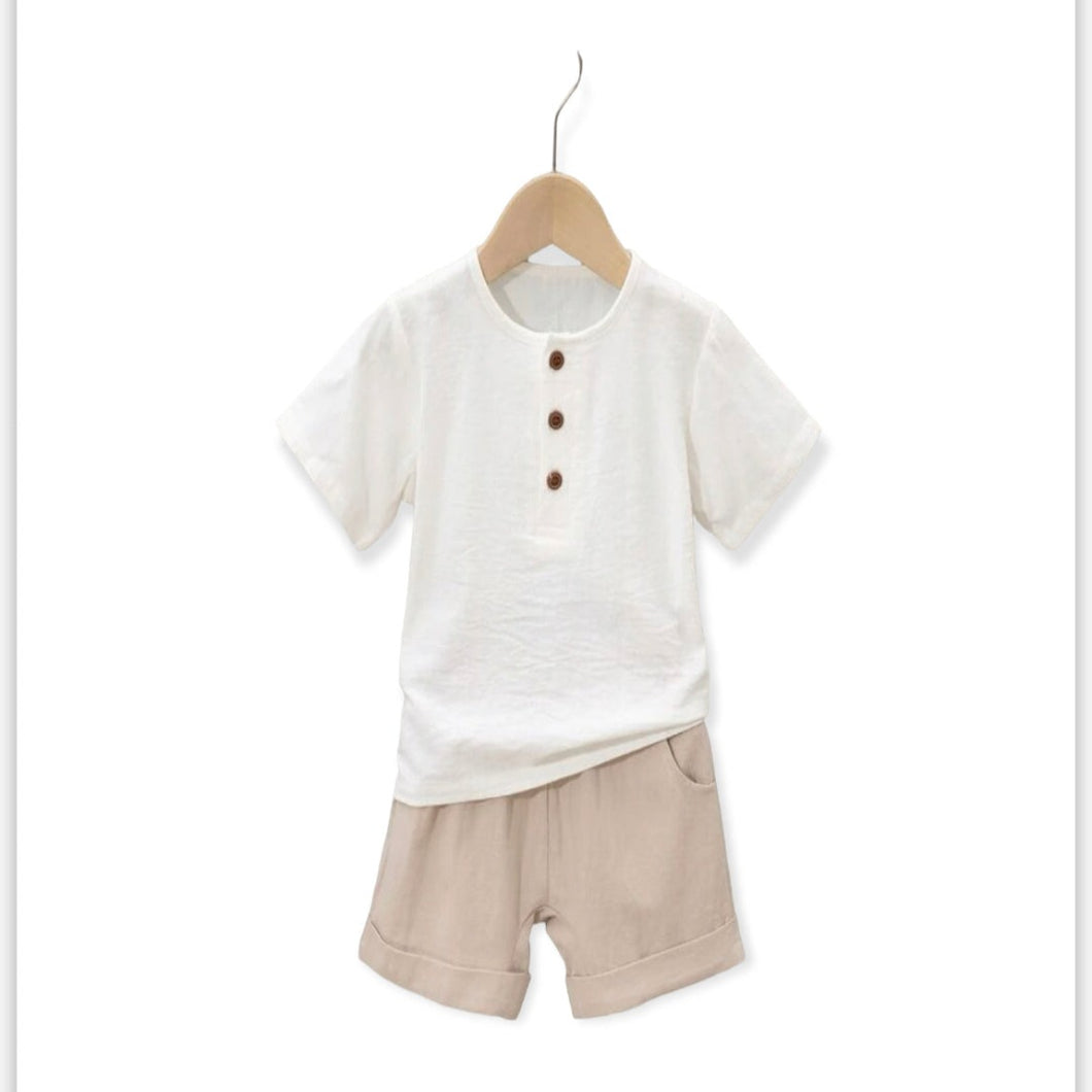 Light weight boys summer set. Featuring white short sleeve top with buttons and creams colored shorts.